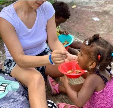 Volunteers Feeding Children