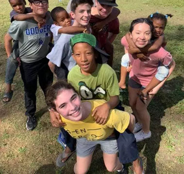 Students Giving Kids Piggy Back Rides